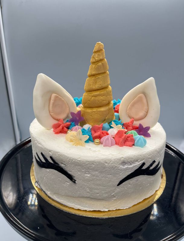 Imagen de tarta con forma de cabeza de unicornio con colores